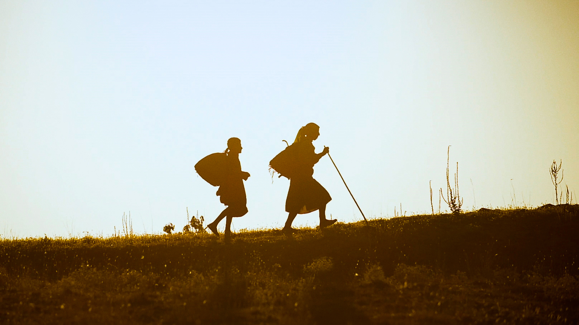 Trailer still frame from Honeyland, two woman walking along path