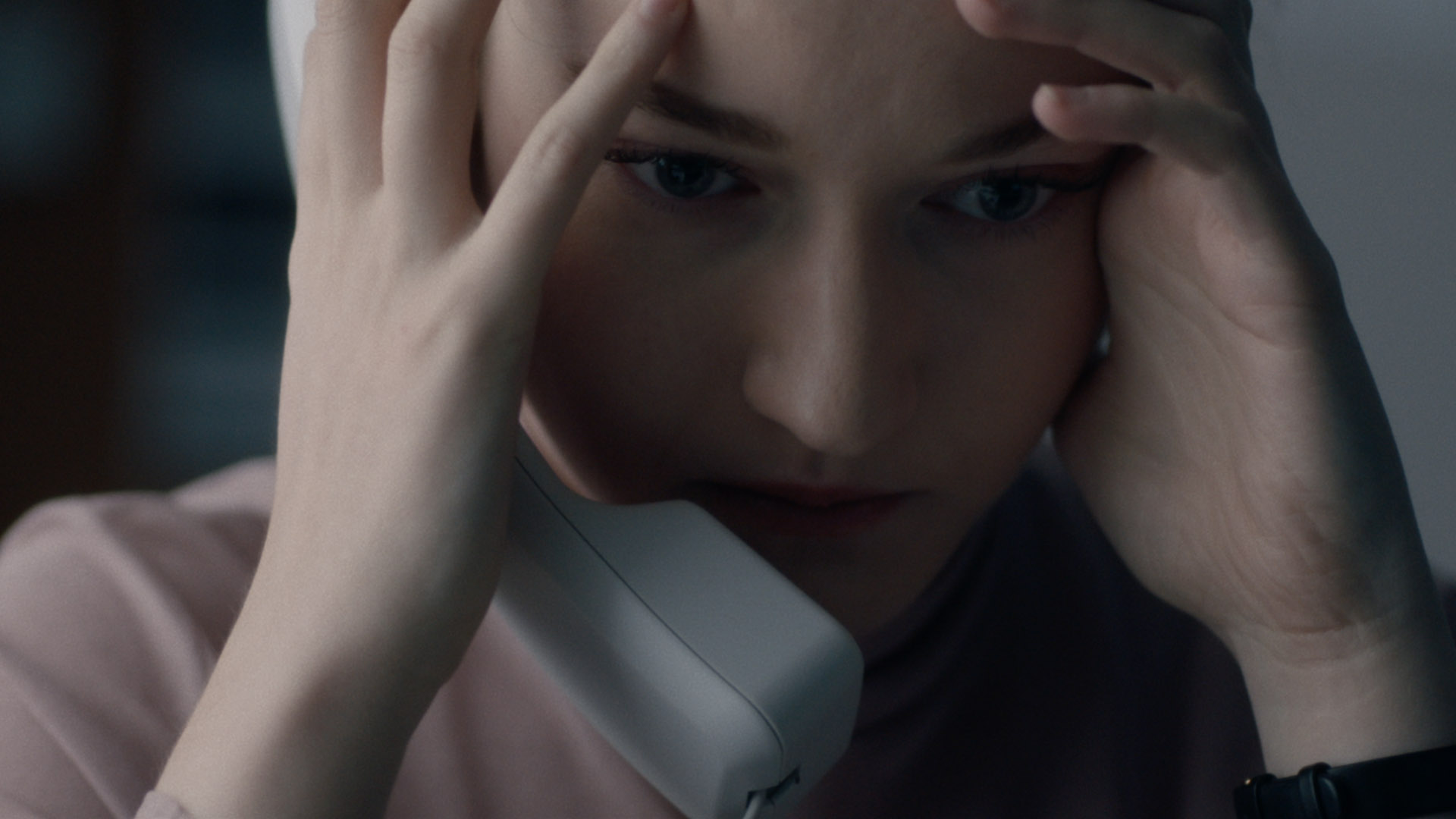 Trailer still frame from The Assistant, woman on phone